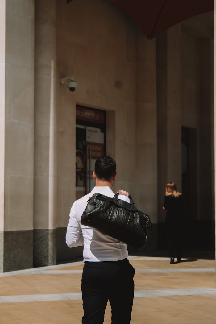 Crafting Captivating Headlines: Your awesome post title goes here A man carrying a leather bag walks on a city street in London, England.